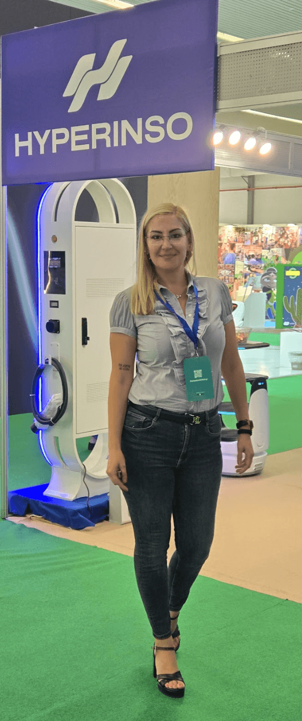 A member of the Hyperinso team in front of a charger at the 89th TIF stand