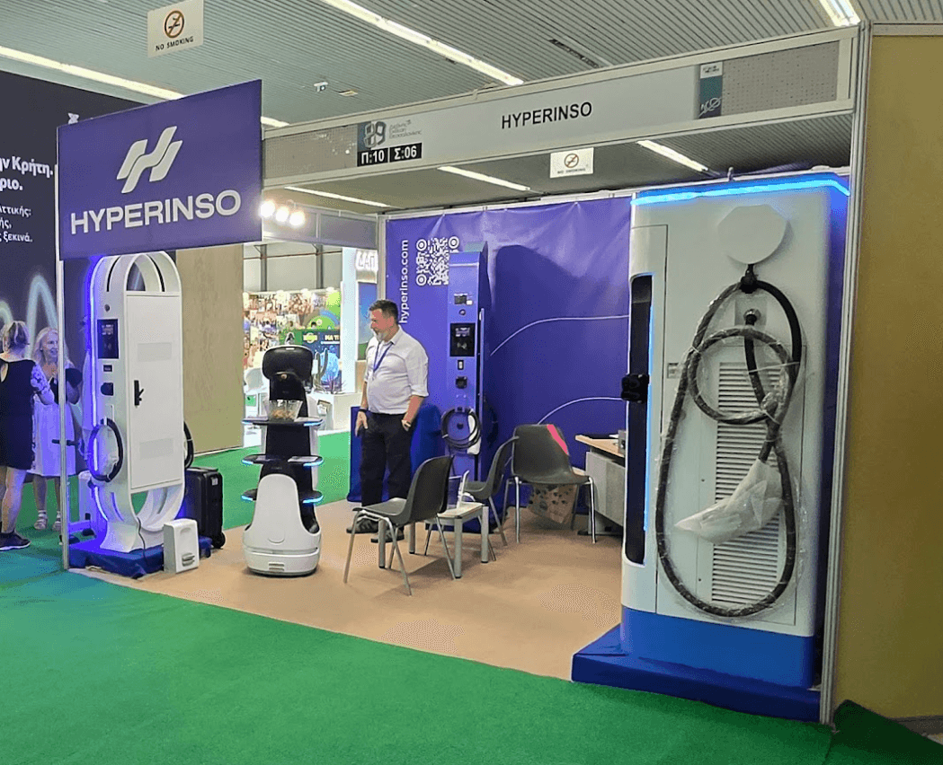 A side view of the Hyperinso stand with charging stations and robots