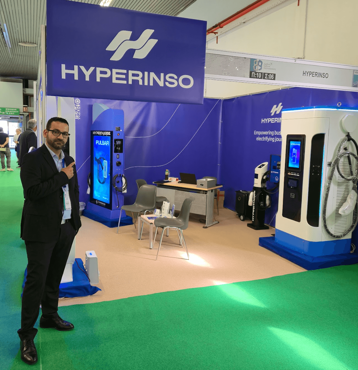 A Hyperinso representative in front of the chargers on the exhibition stand